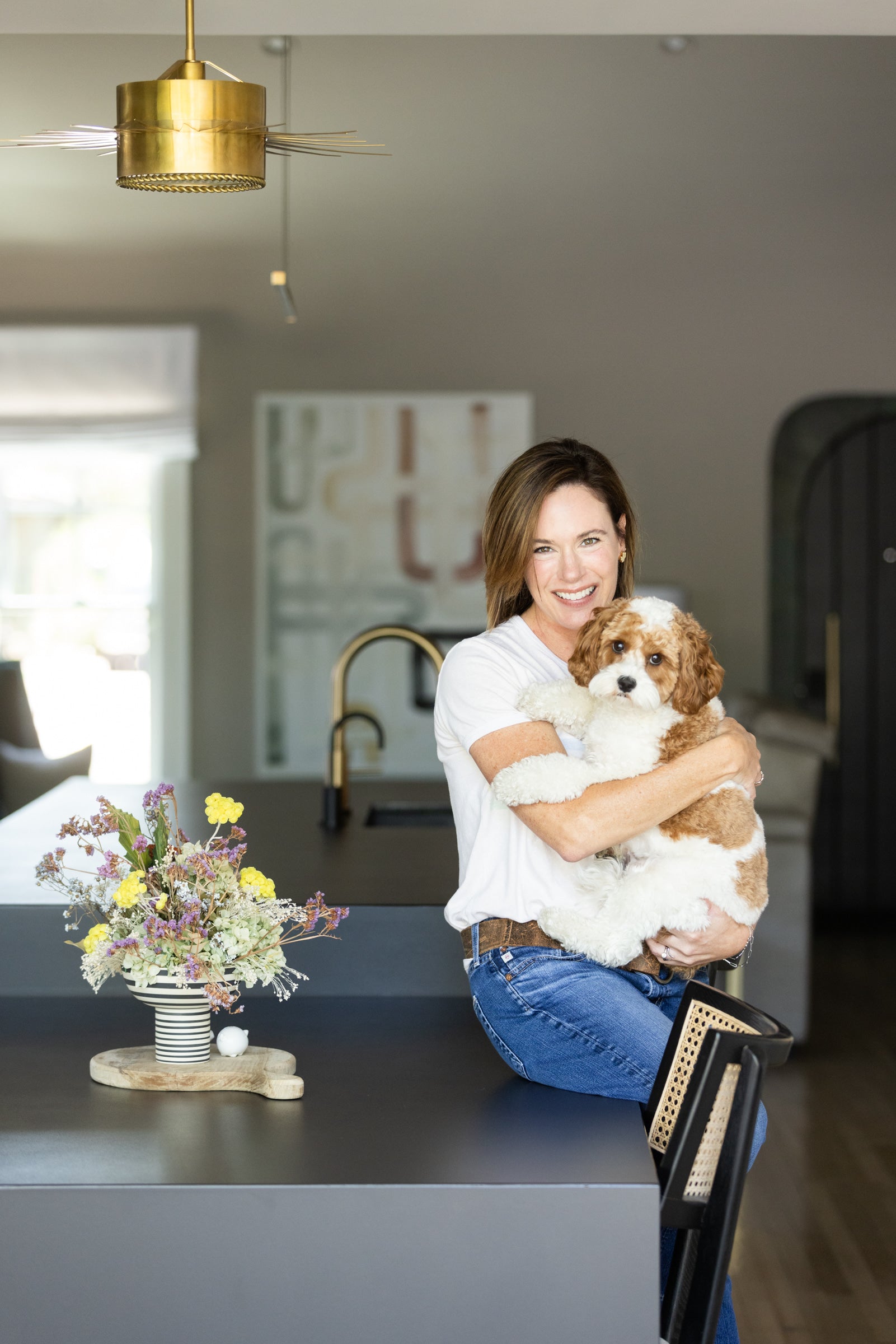 Kari Escobar with dog Romeo. Owner of The Curated Client.