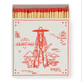 Load image into Gallery viewer, Vintage matchbox with a cowgirl, lasso, and lightening bolt in red.
