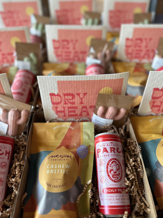 Pop-by gift for AZ Real Estate Agents. It includes a mocktail, a cactus-shaped soap, chocolate brittle and a swedish dish towel.